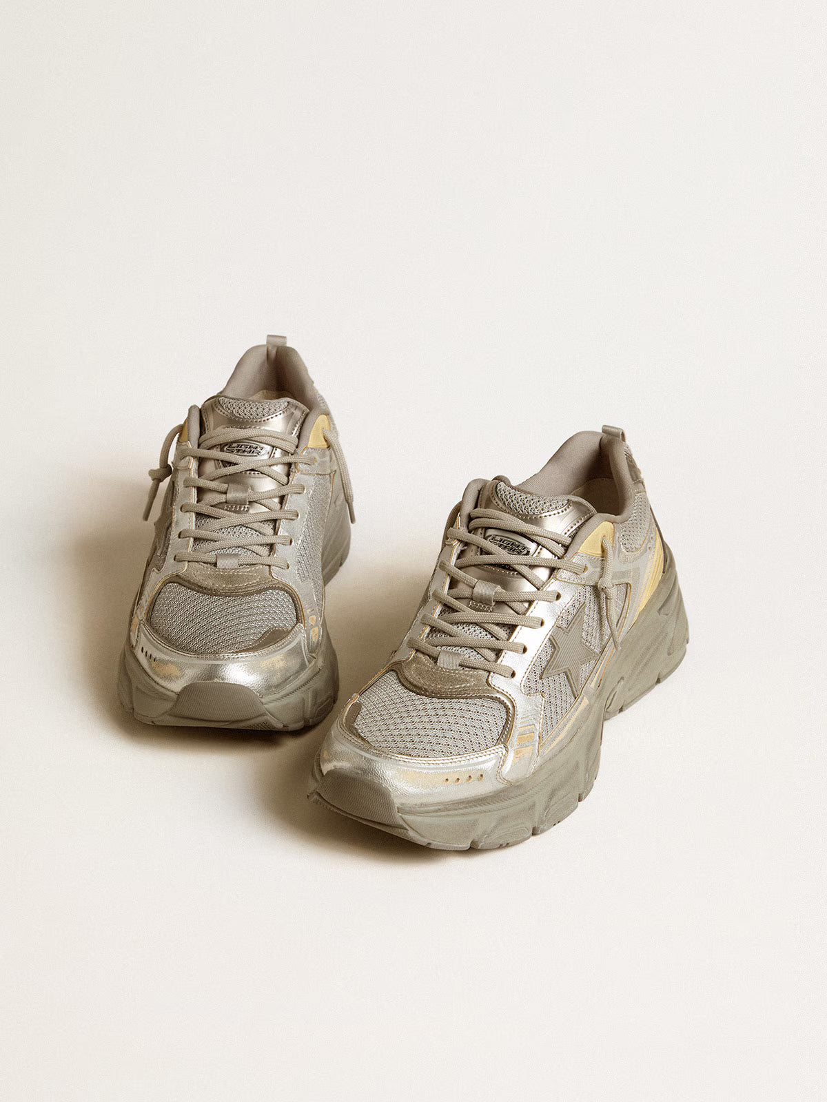Golden Goose Lightstar sneakers featuring a metallic silver and grey leather