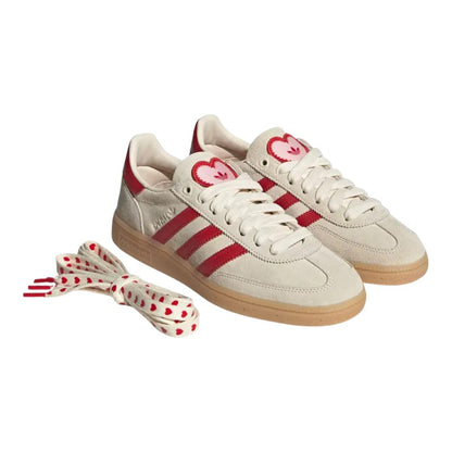 Luxurykicks.store Adidas Handball Spezial Valentine’s Day sneakers in cream suede with red heart tongue details.