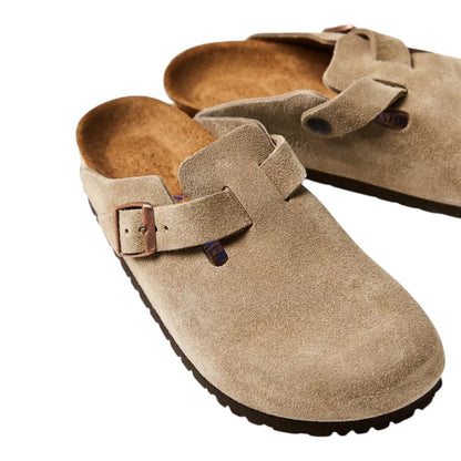 Luxurykicks.store Birkenstock Boston clogs in taupe suede with adjustable buckle strap and cork-latex footbed.