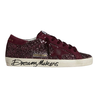 Luxurykicks.store Golden Goose Super-Star sneakers in cherry red glitter with Dream Makers text on the distressed sole
