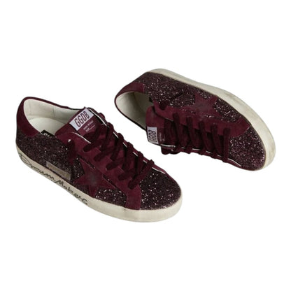 Luxurykicks.store Golden Goose Super-Star sneakers in cherry red glitter with distressed leather and signature star