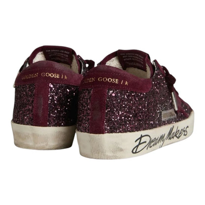 Luxurykicks.store Golden Goose Super-Star LTD sneakers in cherry red glitter with distressed soles and heel detail