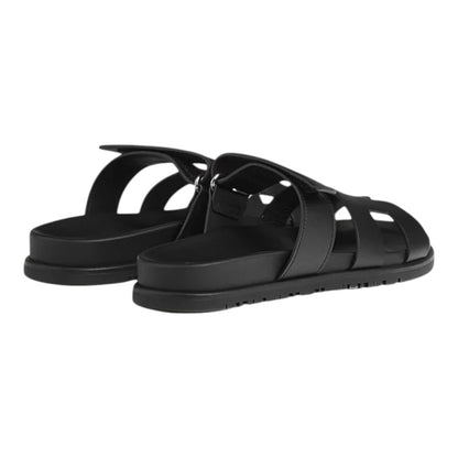 Luxurykicks.store Hermes Chypre black leather sandals with adjustable strap and flat sole, rear view