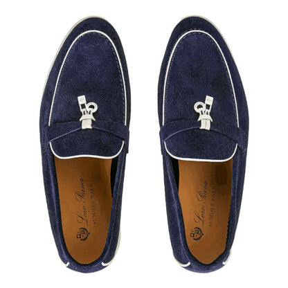 Luxurykicks.store Loro Piana navy blue suede loafers with white trim and signature charm detail, top-down view.