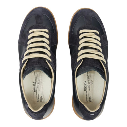 Luxurykicks.store Maison Margiela black suede and leather lace-up sneakers with cream laces, top-down view