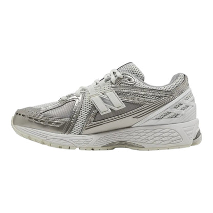Luxurykicks.store New Balance 1906R sneaker in metallic silver with breathable mesh and synthetic overlays.