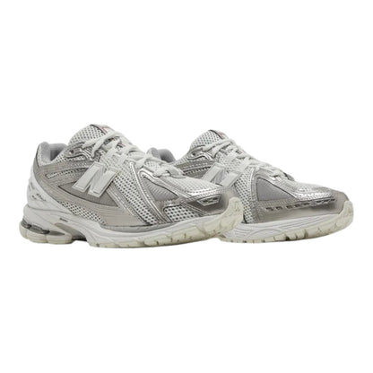 Luxurykicks.store New Balance 1906R sneakers in metallic silver with breathable mesh and synthetic overlays.