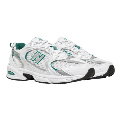 Luxurykicks.store New Balance 530 sneakers in white mesh with silver and green accents and ABZORB cushioning.