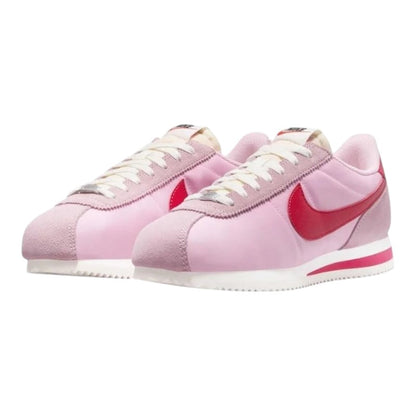 Luxurykicks.store Nike Cortez trainers in soft pink and fire red with sail accents and a classic leather silhouette.