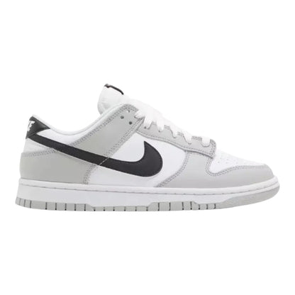 Luxurykicks.store Nike Dunk Low SE Lottery Pack sneaker in grey and white with a black swoosh, side profile view.