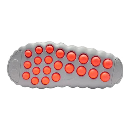 Luxurykicks.store Nike Mind 001 sneaker outsole in light smoke grey with vibrant orange circular traction pods