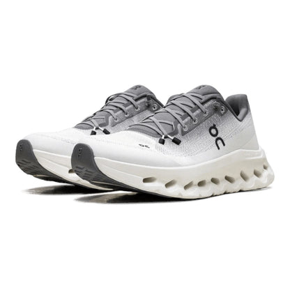 Luxurykicks.store ON Cloud CloudTilt women's running shoe in rock ivory with mesh upper and responsive white midsole.