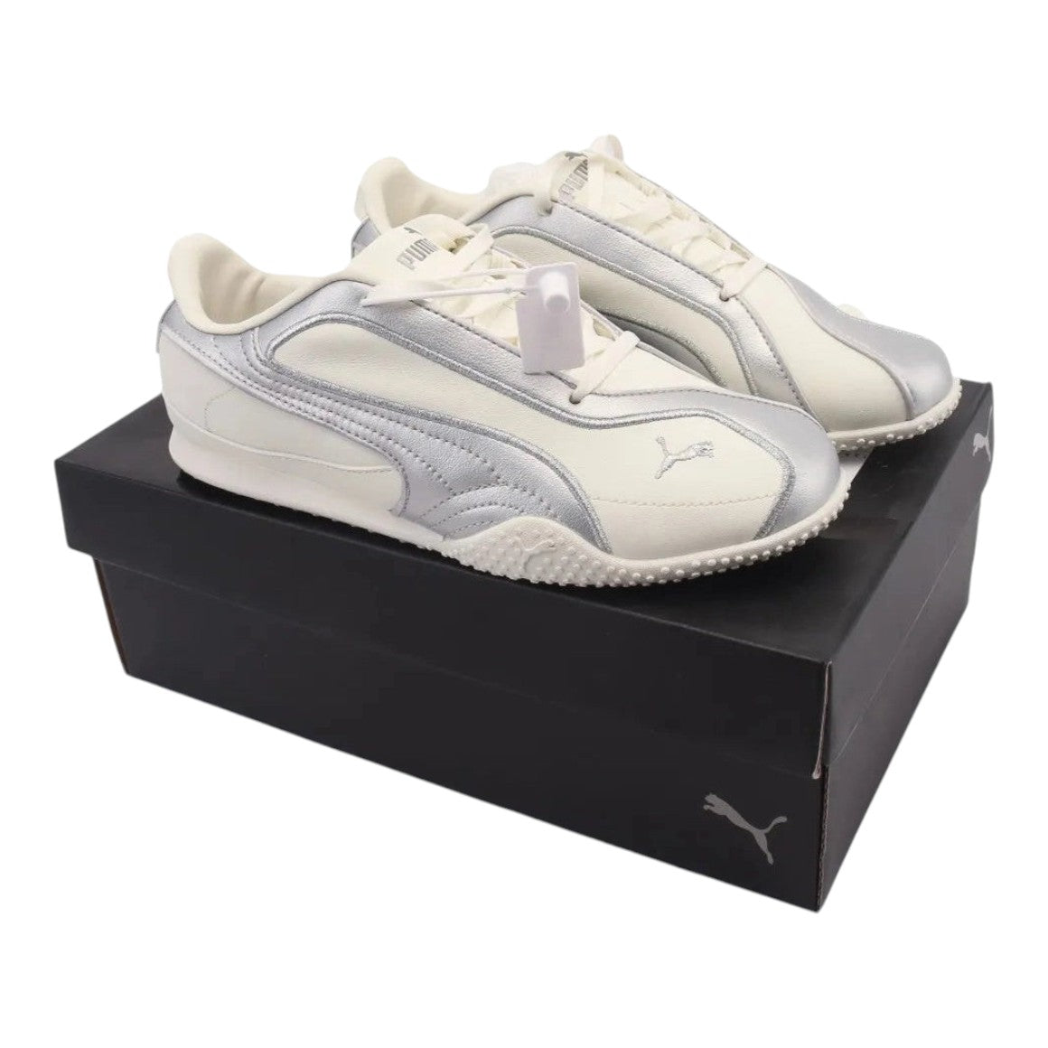 Luxurykicks.store Puma Wmns Bella V2 leather sneakers in warm white with silver accents on a black shoebox