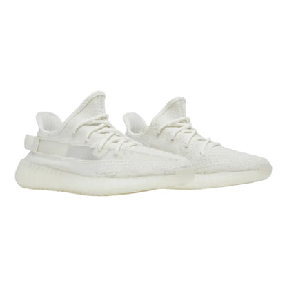 Luxurykicks.store Adidas Yeezy Boost 350 V2 Bone sneakers featuring a cream Primeknit upper and Boost cushioning.