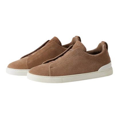 Luxurykicks.store ZEGNA Triple Stitch low-top sneakers in brown suede with signature detailing and white rubber soles.